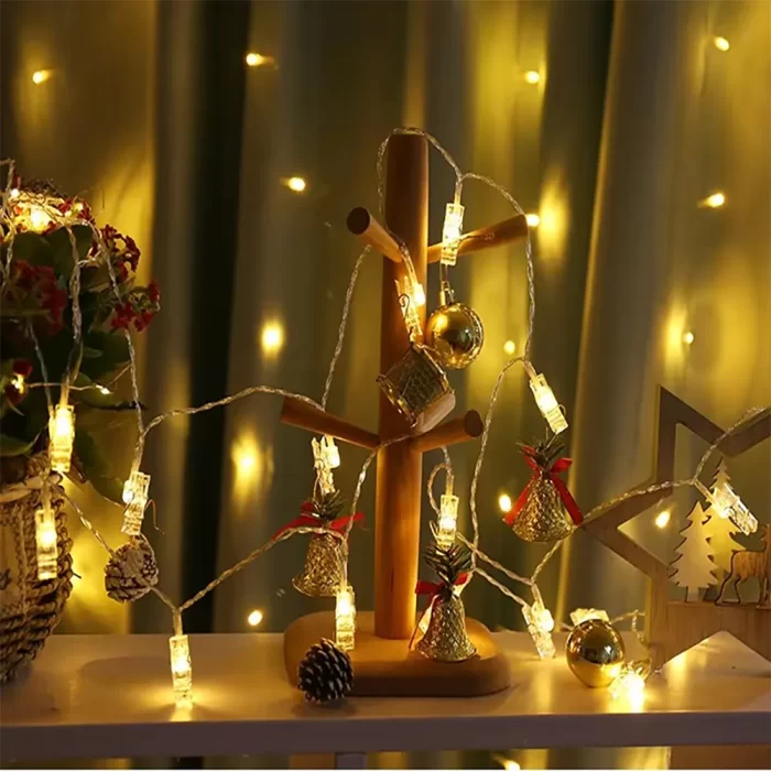 photo display lights bathe Christmas bells and ornaments in golden warmth, filling the scene with festive cheer and holiday magic