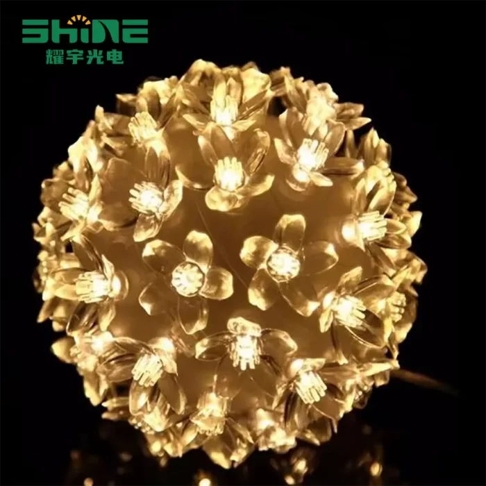 LED fairy lights for bedroom glowing with warm white flower balls; battery-operated to create a soft, cozy ambiance perfect for intimate evenings.