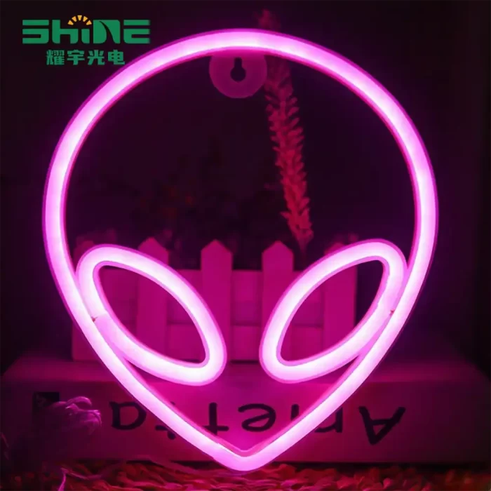 Pink alien neon sign glowing indoors for party decoration
