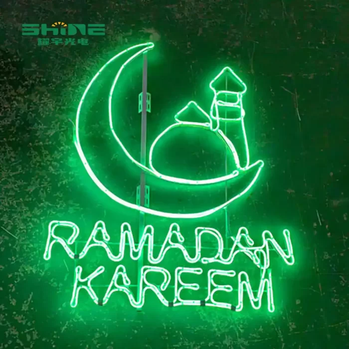 The bright green LED 2d motif light features a large crescent moon, a mosque/minaret outline, and the words "RAMADAN KAREEM" underneath.