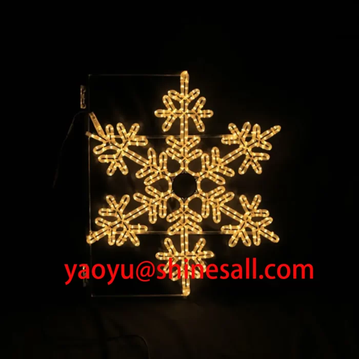 A flat 2D LED snowflake motif light with warm white lights against a black background, ideal for pole or wall mounting.