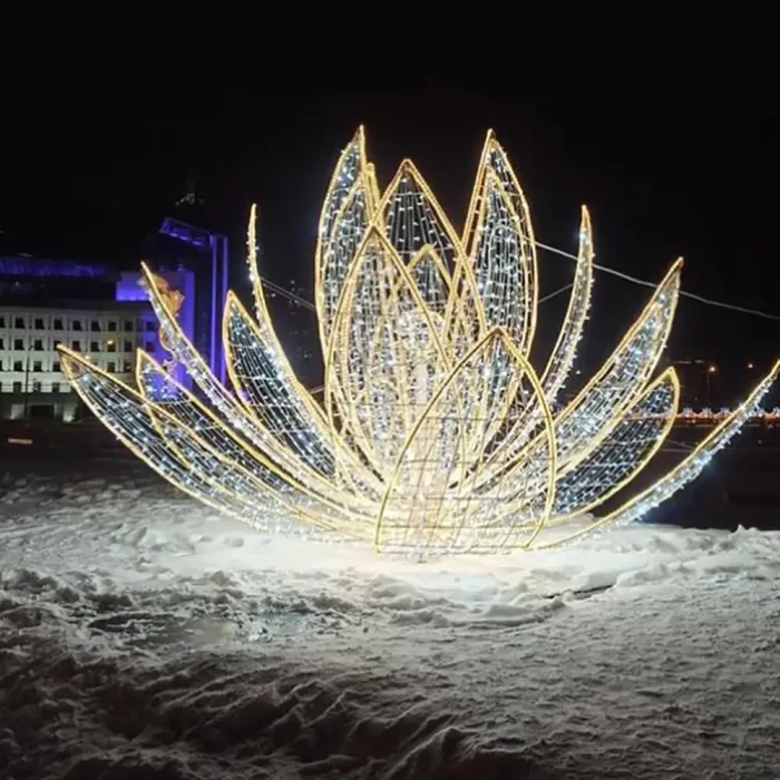 A stunning 3D LED motif light sculpture resembling a lotus flower, illuminated at night in an outdoor snowy setting. Perfect for festive and cultural events.