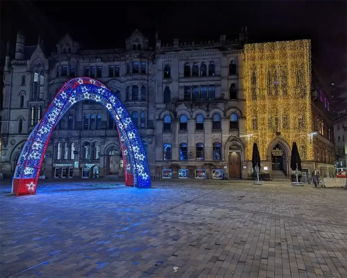 Outdoor LED Christmas light sculpture with visitors for scale