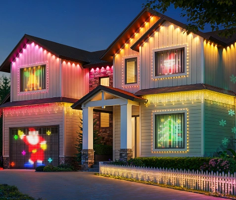 Two-story home covered in animated, color-changing motif Christmas lights that create festive images in the windows and along the roofline.