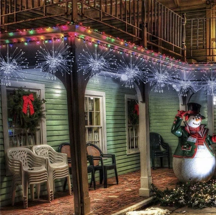 Outdoor LED firework lights mounted under eaves creating a starburst effect, suitable for IP-rated weather-resistant setups