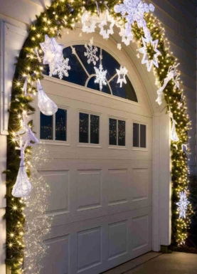 Snowflakes and angels hanging above a garage door, with glowing lights creating a magical Christmas scene.