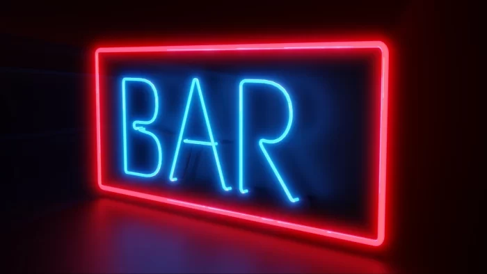 Blue neon BAR letters inside a red rectangular outline, a simple and scalable light motif example for hospitality branding