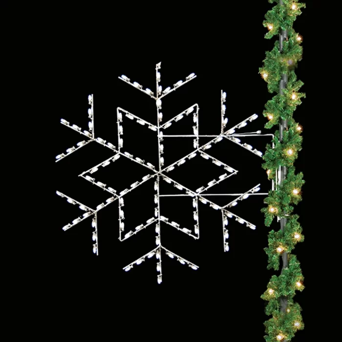 Cool white snowflake street pole motif light mounted beside garland for winter decoration programs