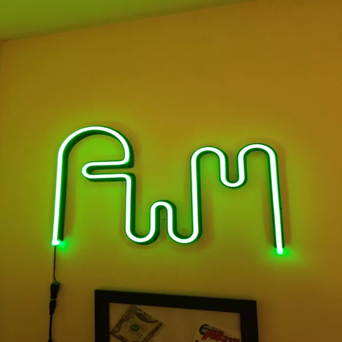 Single continuous green neon line forming a minimal wave shape, representing a dynamic and responsive light motif in modern design