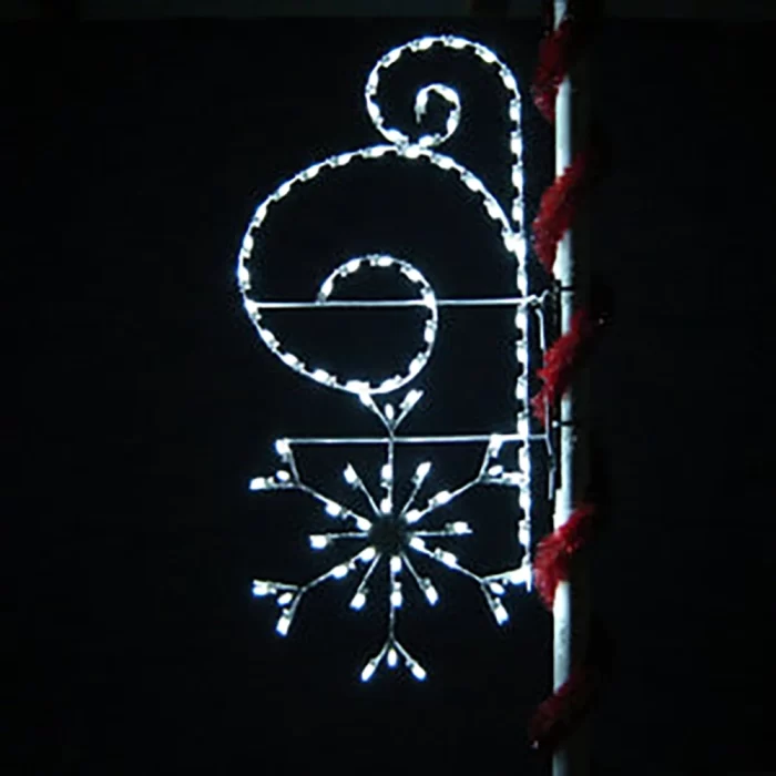Small swirl-and-snowflake street pole motif light in cool white LEDs for side streets and accent zones