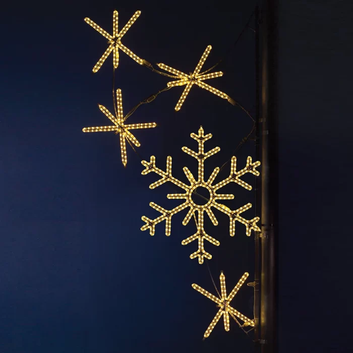 Warm white snowflake street pole motif with starburst accents on commercial LED rope lights