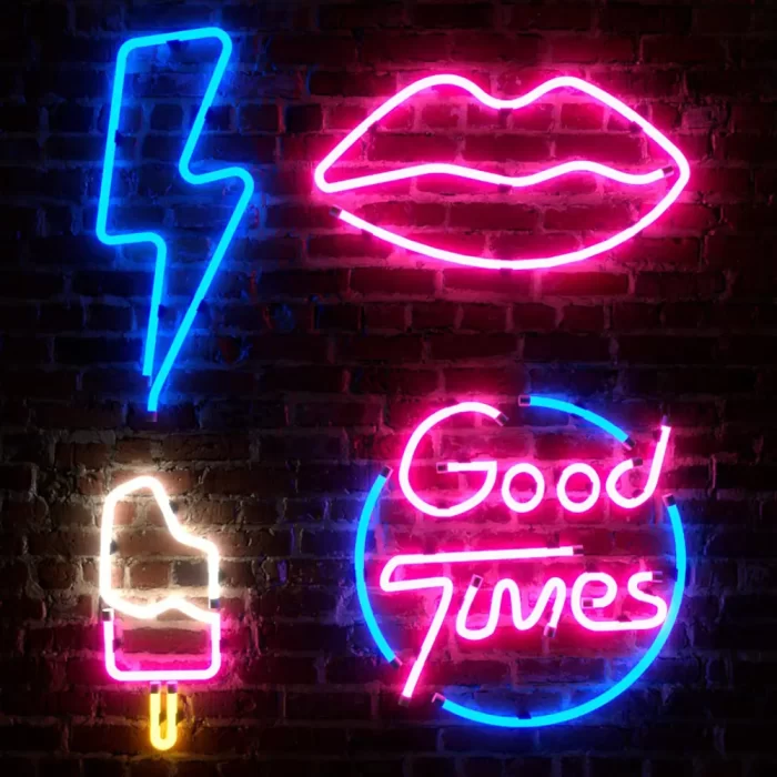 Neon icons and “Good Times” text on a brick wall, showing how motif-heavy visuals strengthen recall across promotional brand touchpoints