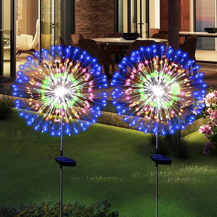Decorative firework starburst lights installed on a lawn near a hotel or residential entrance