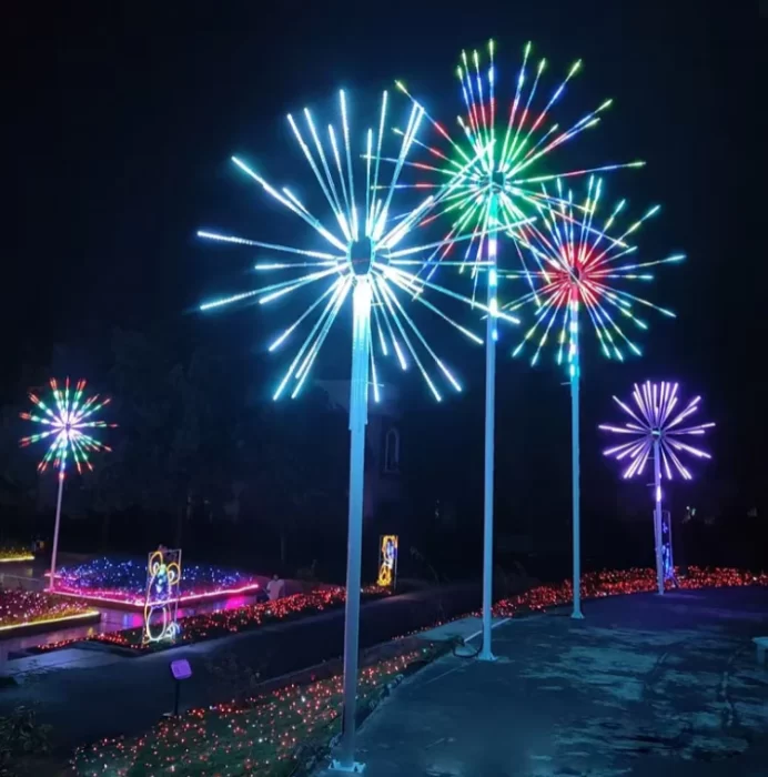 Commercial LED firework lights in different heights installed in a garden pathway display, showing RGB, white and multicolor starburst options.
