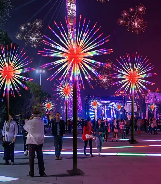 Large LED firework lights installed in a busy commercial plaza, creating colorful RGB starburst effects for shopping centers and entertainment venues.