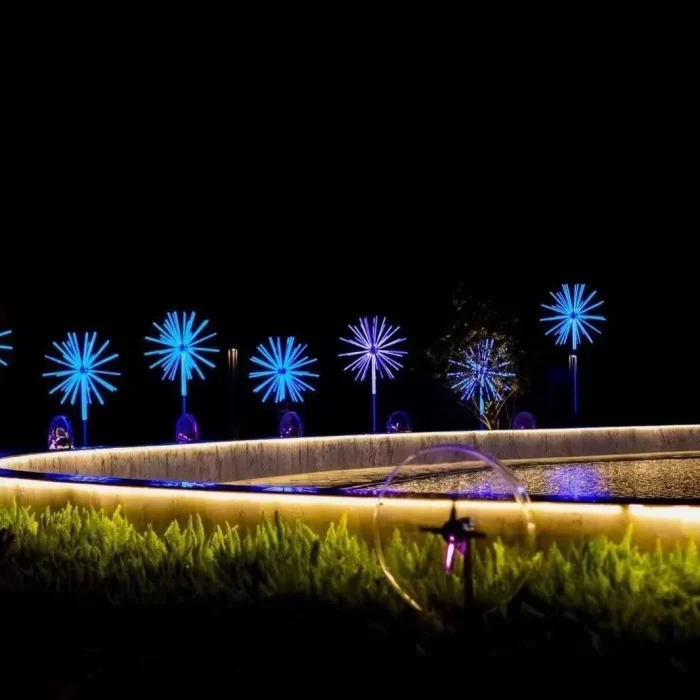 Solar-style firework lights used as blue landscape accents along pathway edges and water features